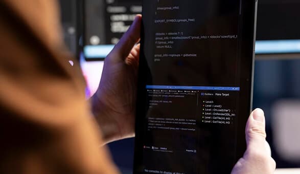 Person working with code on tablet device