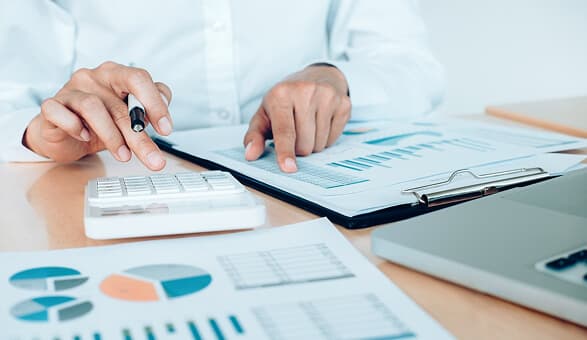 Financial charts and graphs with person analyzing data