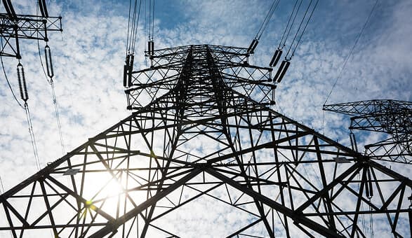Power transmission tower against blue sky